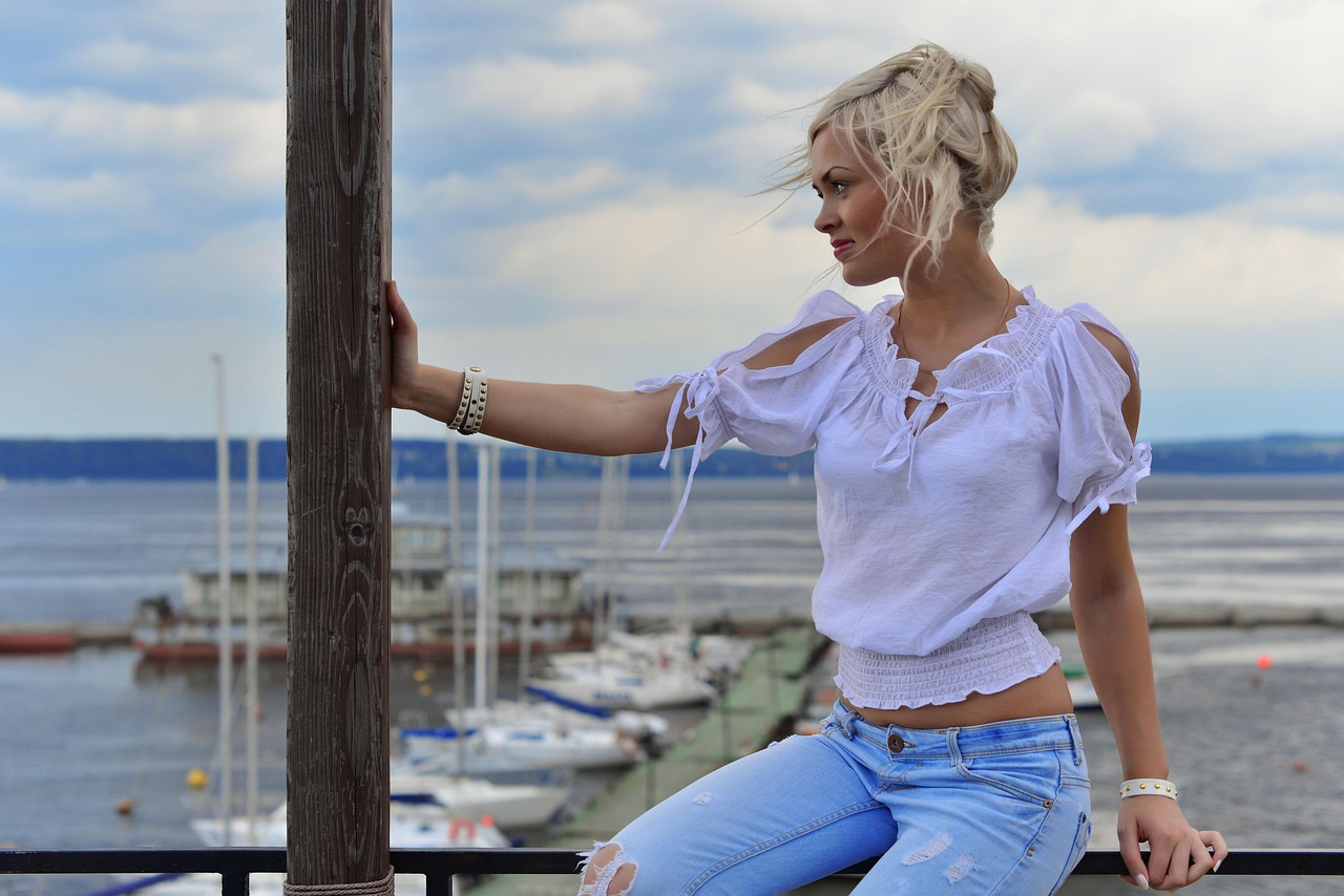 blonde in profile, sky, water, blue jeans, bunch of hair, white t-shirt, sea, waves, beach, nature, faces, lady